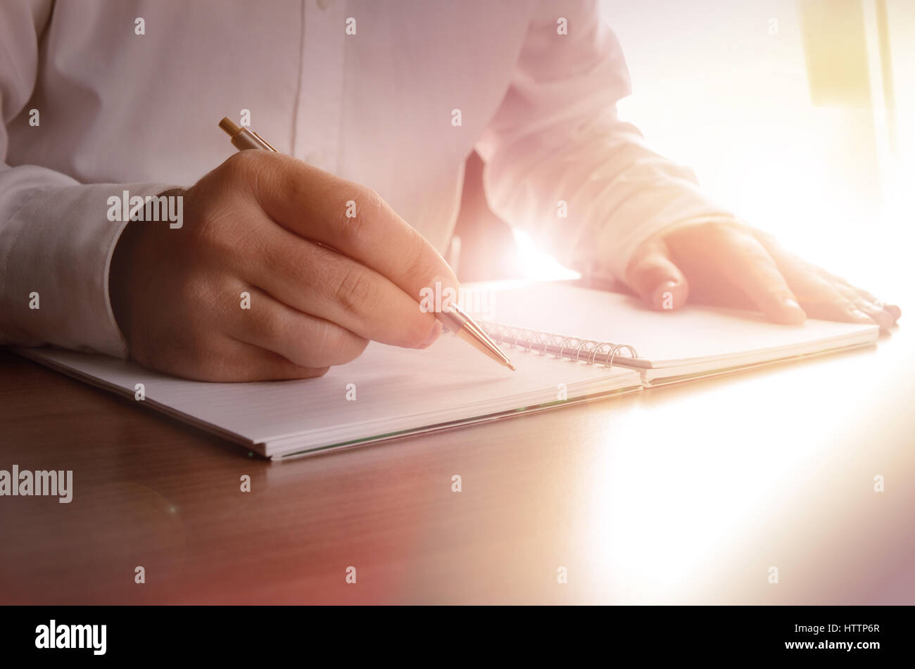 Concept of a businessman writing on a notebook. Image can be used for several purposes like: background, website banner, promotional materials, poster Stock Photo
