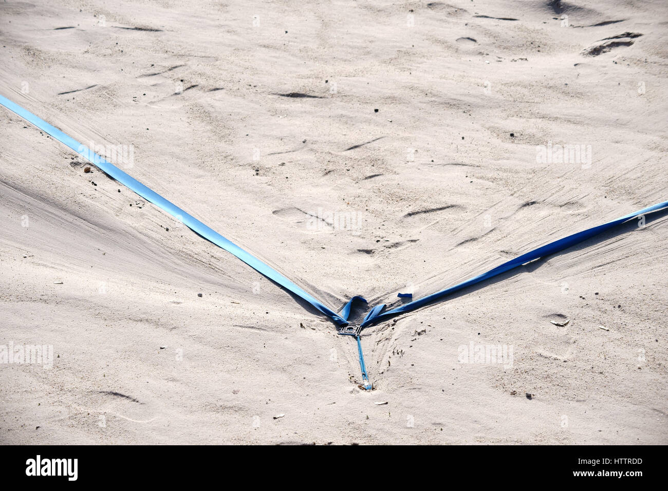 The marking of a beach volleyball field with tension cables in the sand beach. Stock Photo