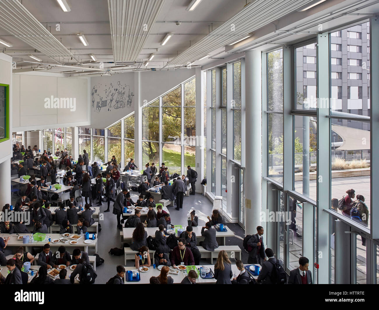 Lunch time in the dining hall. Kensington Aldridge Academy, London, United Kingdom. Architect
