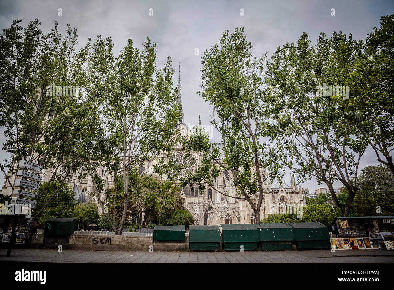 People wlaking in the Siene street shore, with Notre Dame in the back, Paris. Stock Photo
