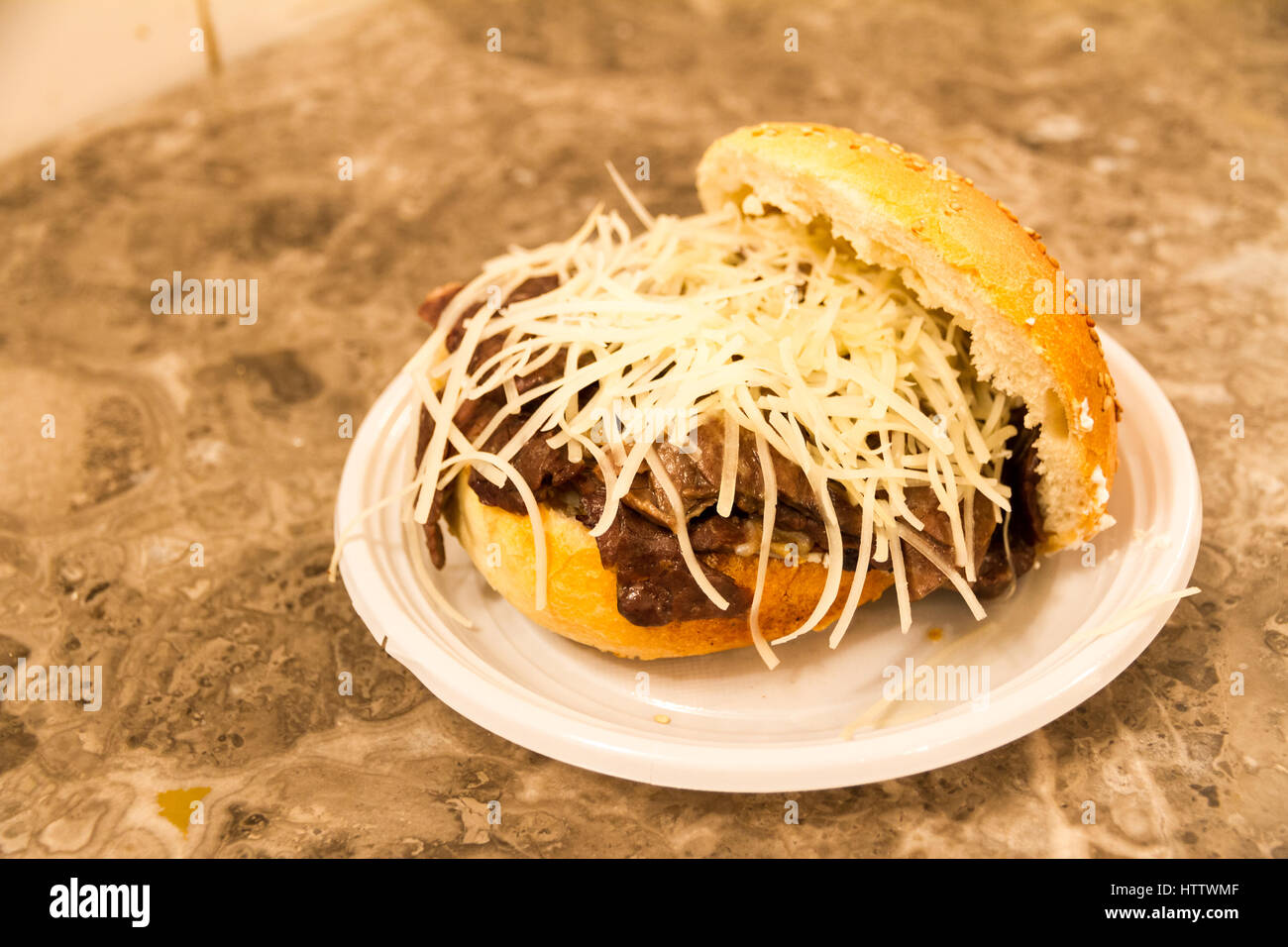 'Pani ca meusa' is a Sicilian street food. Literally, its name means 'bread with spleen'; its Italian name is 'panino con la milza' Stock Photo