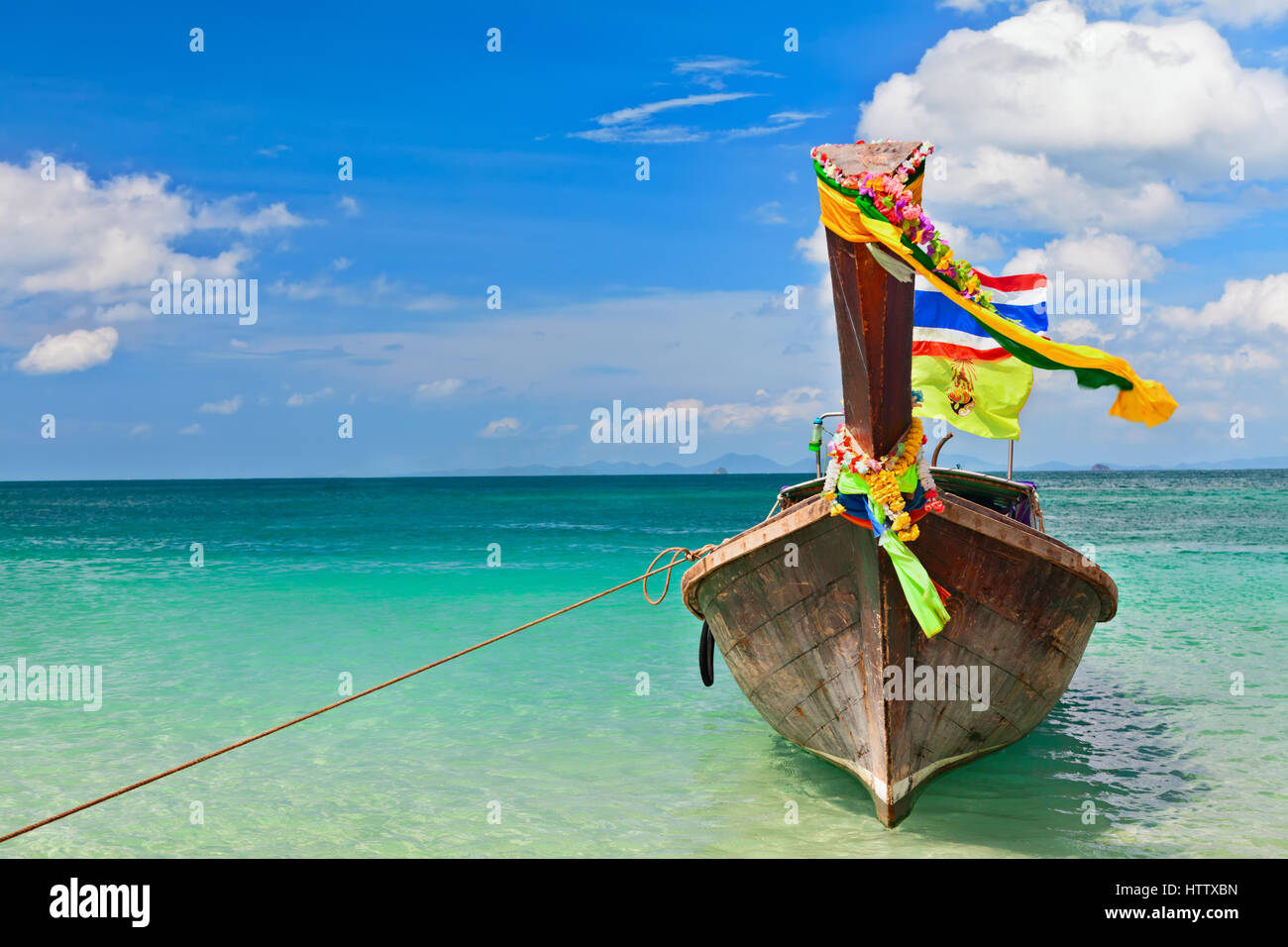 Travel background. Beautiful Thailand tropical sand beach view with decorated traditional longtail boat. Vacation day tour from Phuket to Ko Phi Phi Stock Photo
