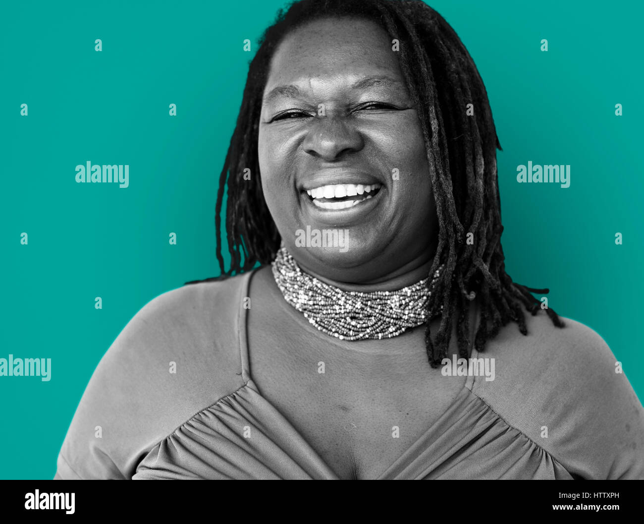 Cheerful african woman in green hi-res stock photography and images - Alamy