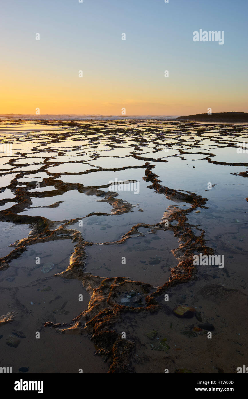 Terraced rock pools on Praia do Farol, Vila Nova de Milfontes, Alentejo,  Portugal at sunset and low tide Stock Photo - Alamy