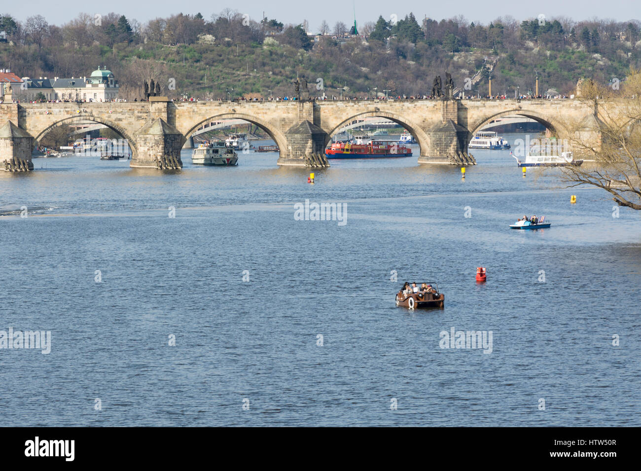 Charles bridge and tourists in pedal boats in Vltava River, Prague, Czech Republic, Europe Stock Photo