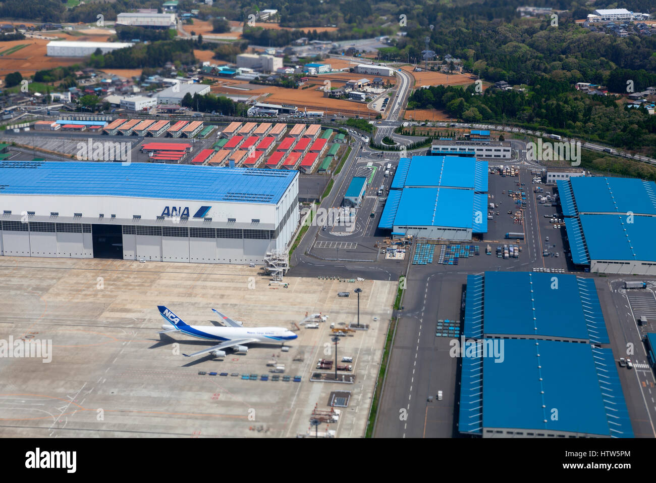 NARITA, JAPAN - CIRCA APR, 2013: Aerial view at the hangars and runway of the Narita International Airport. Narita Airport is the predominant airport. Stock Photo