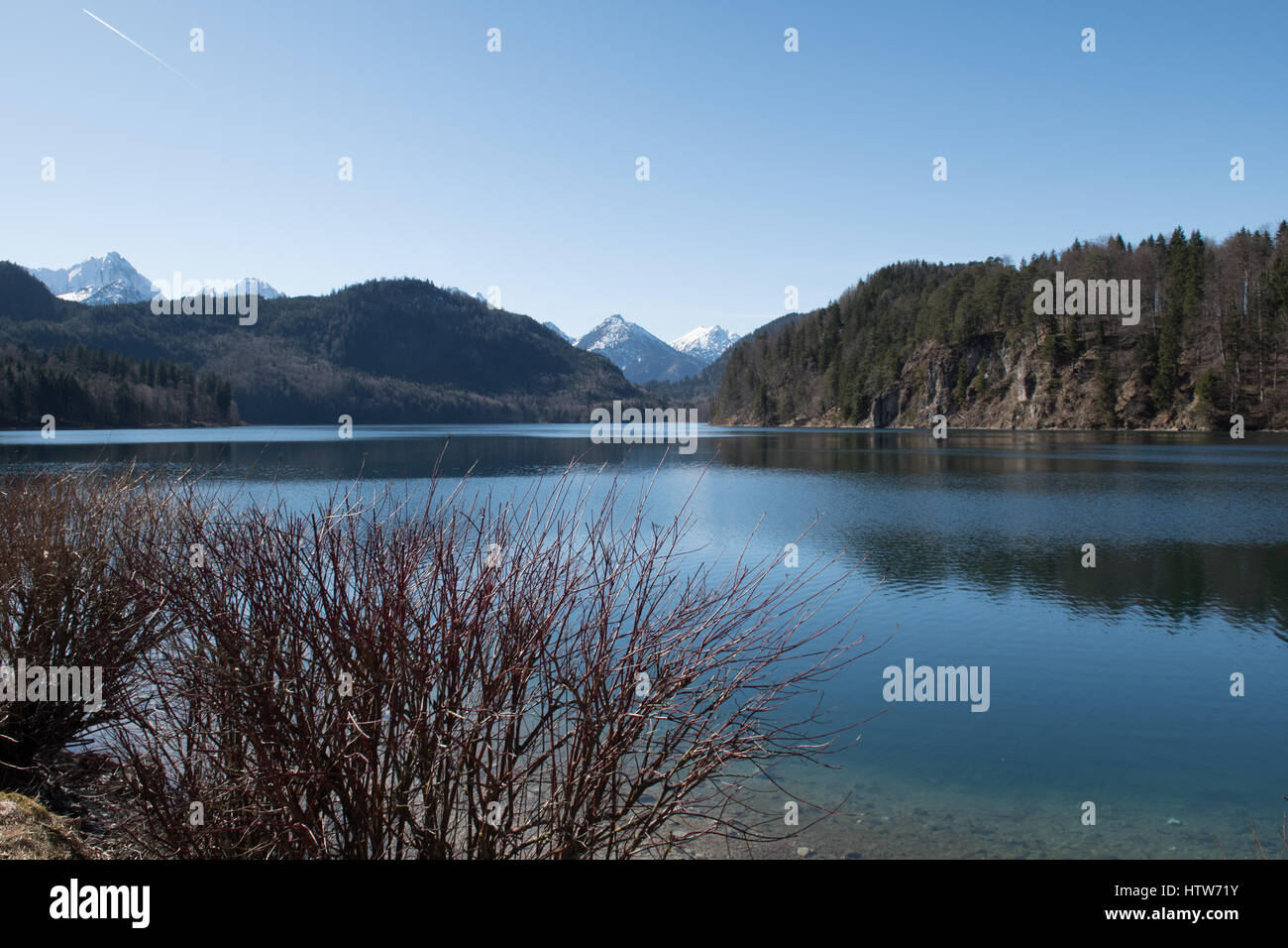 Lake with Alps in background during winter time Stock Photo