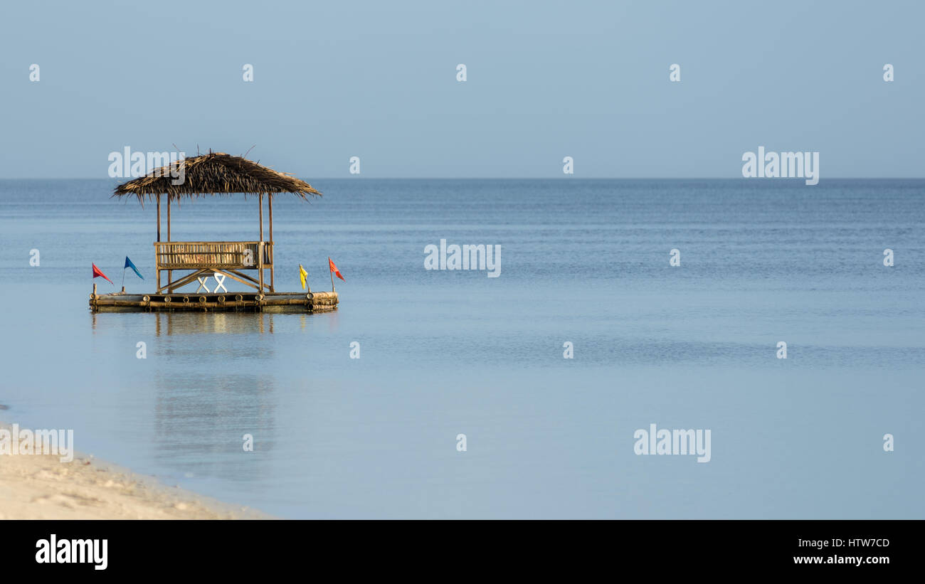 Floating bamboo beach shade on still 