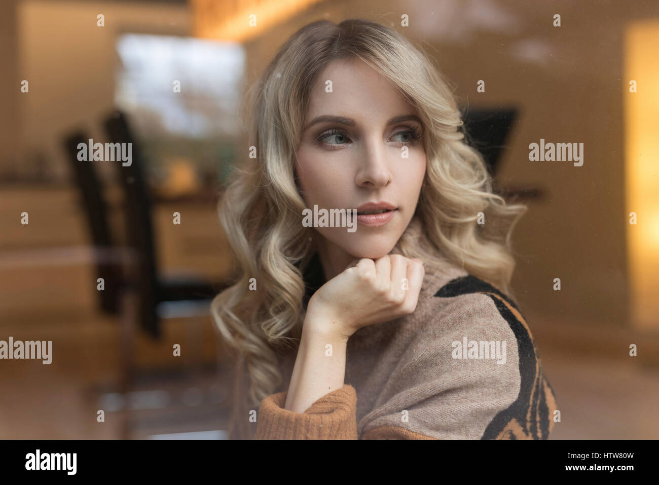 Portrait of a blond woman in the dining room Stock Photo