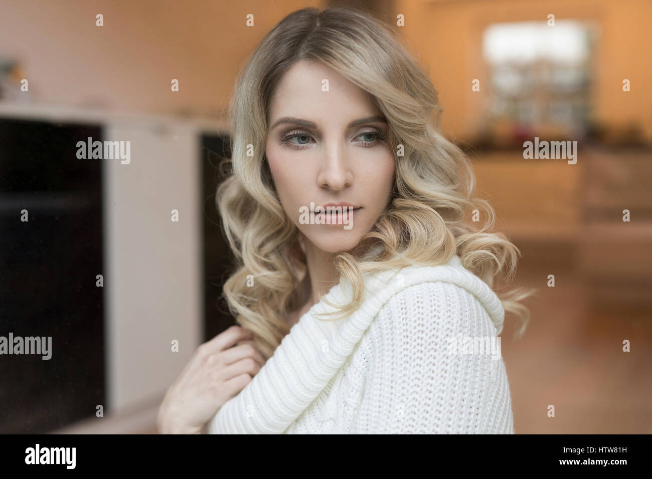 Portrait of a blond woman in the kitchen Stock Photo