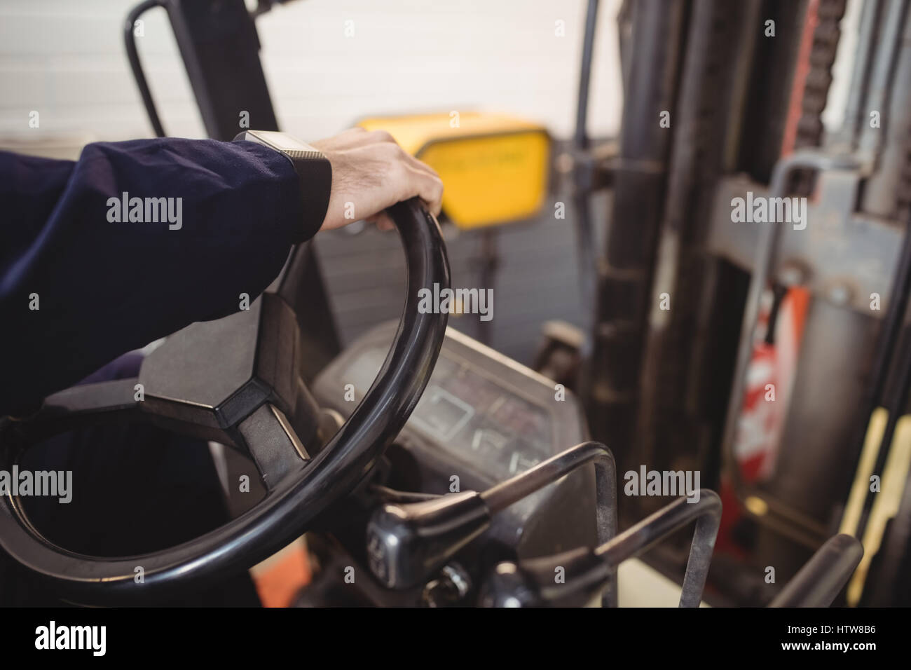 Hands of mechanic driving forklift Stock Photo