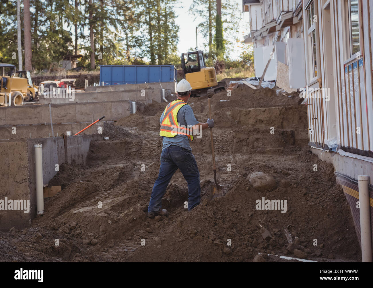 Construction worker working at construction site Stock Photo - Alamy