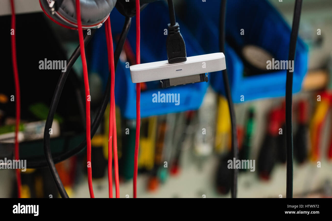 Data cables hanging in repair shop Stock Photo