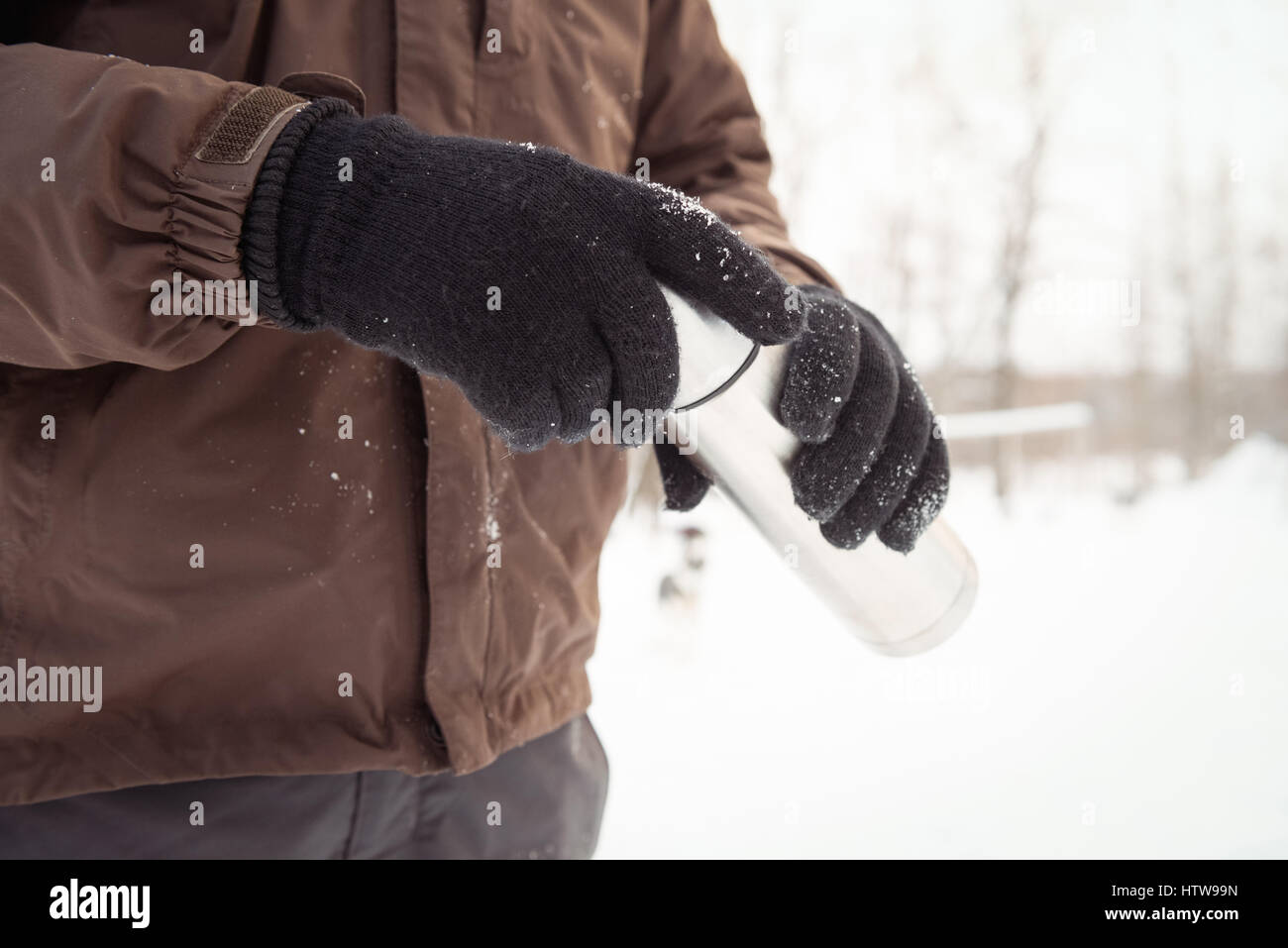 Mid-section of musher holding thermos Stock Photo