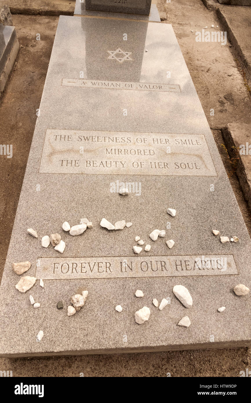Gravestone epitaph for a loved woman. Stones are left by visitors at a Jewish grave. Stock Photo