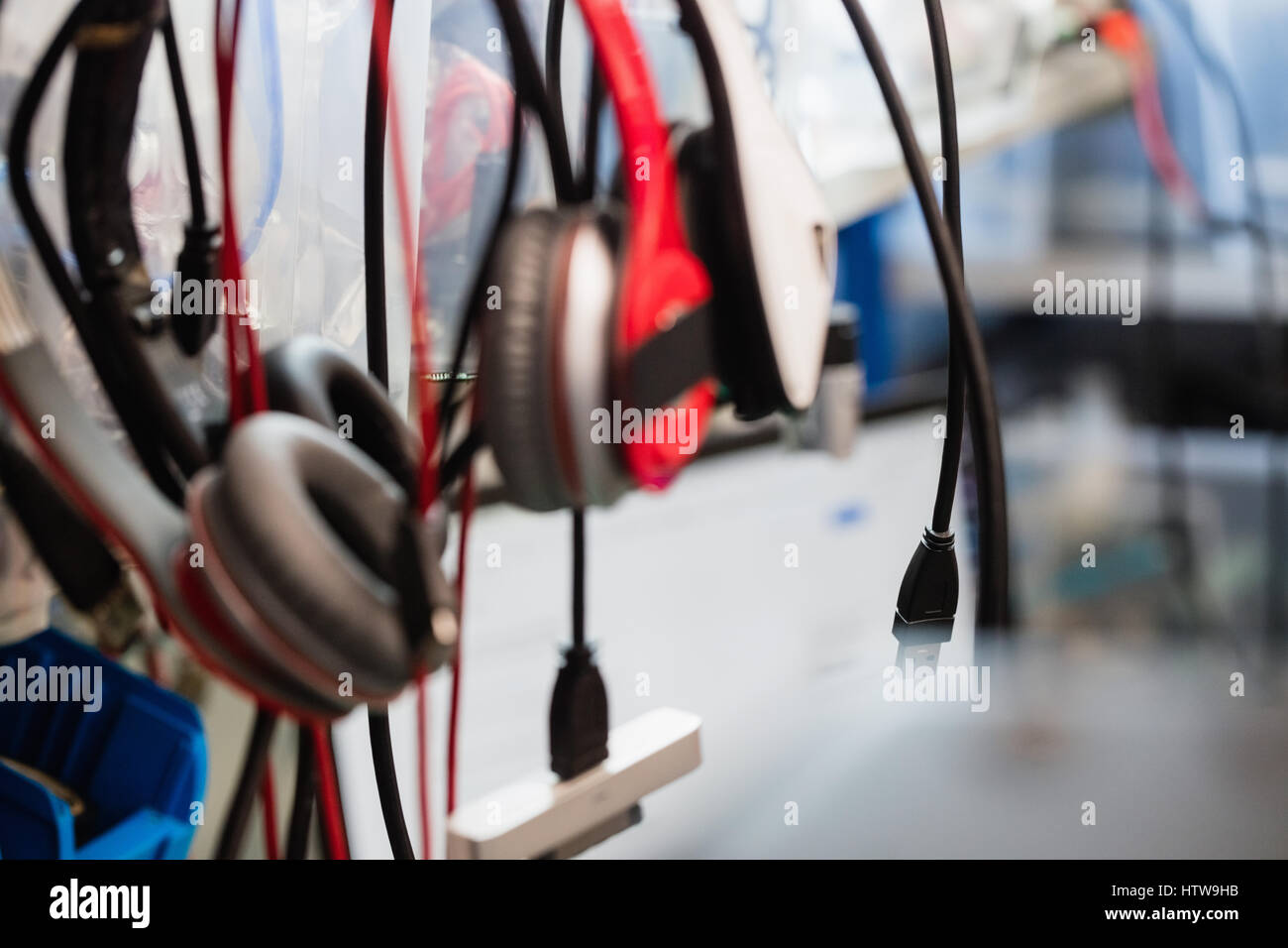 Data cables and headphones hanging in repair shop Stock Photo