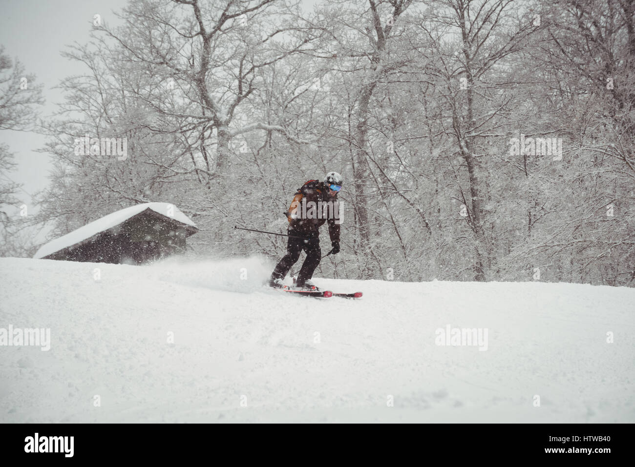 Man skiing down the mountain Stock Photo