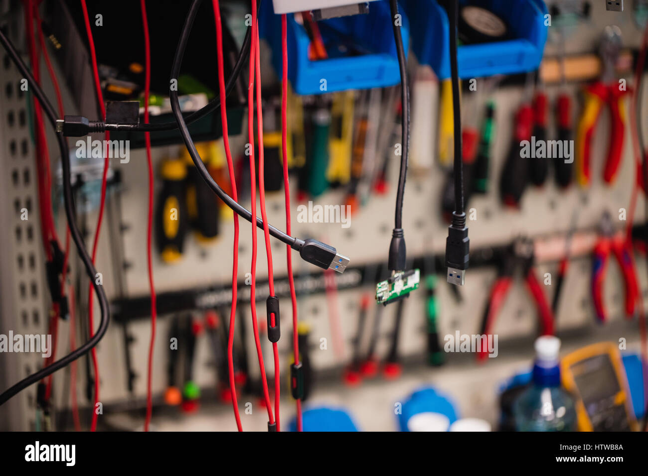 Data cables hanging in repair shop Stock Photo