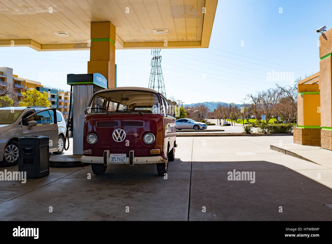 Vintage Volkswagen bus receiving fuel at a modern gas station, Walnut Creek, California, February 26, 2017 Stock Photo