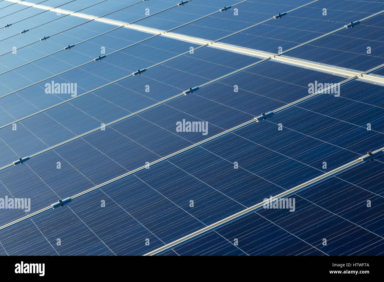 Solar panels in array Capturing sunlight to convert it to green renewable energy. It's clean. No pollution and no noise. Stock Photo
