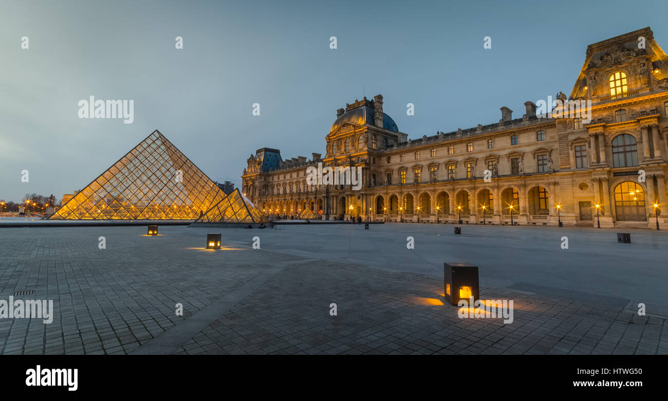 The courtyard of the Louvre (Pyramide du Louvre) at dusk / evening without people or tourists. Stock Photo