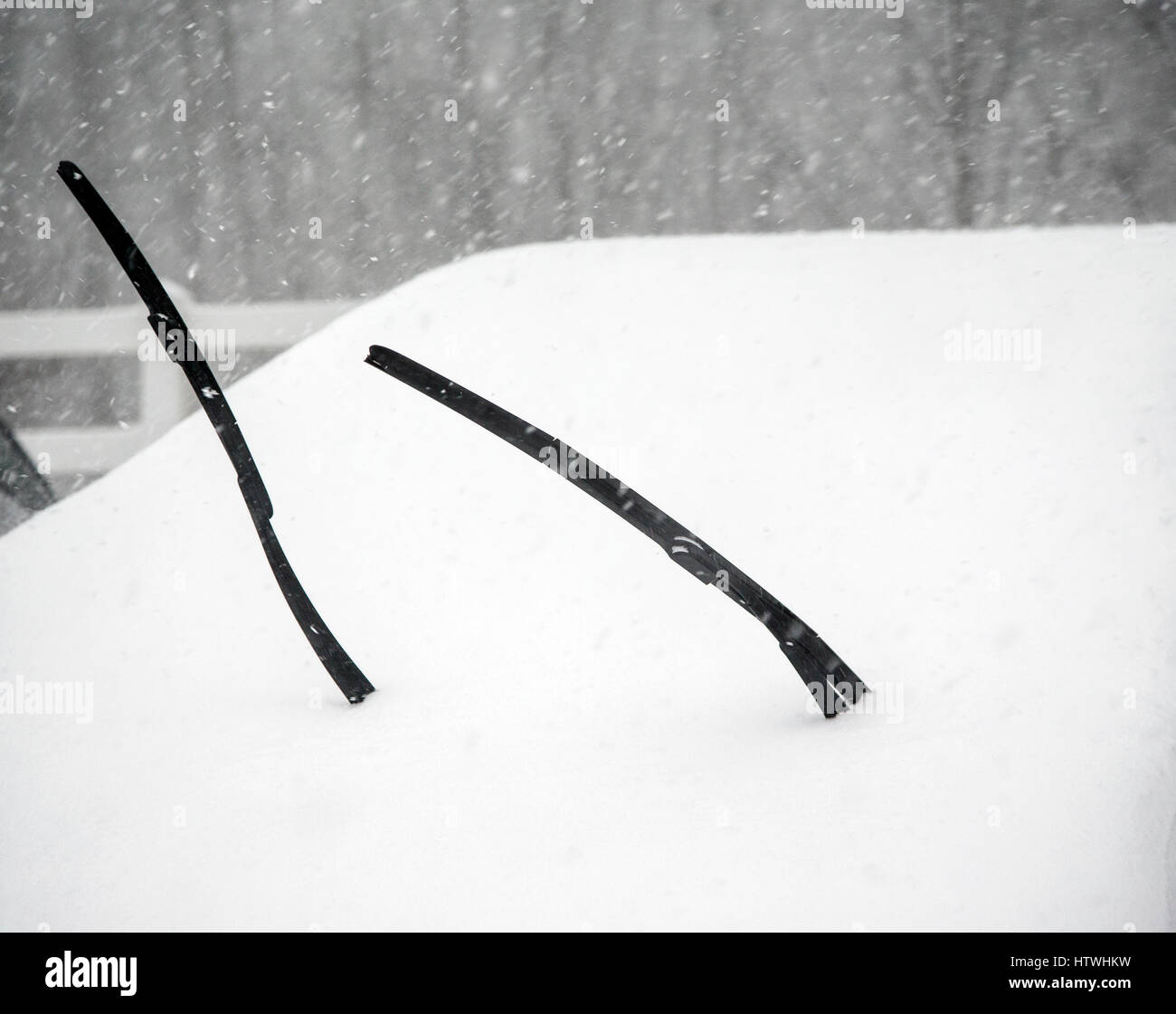 Windshield wipers on a car during a snow storm Stock Photo