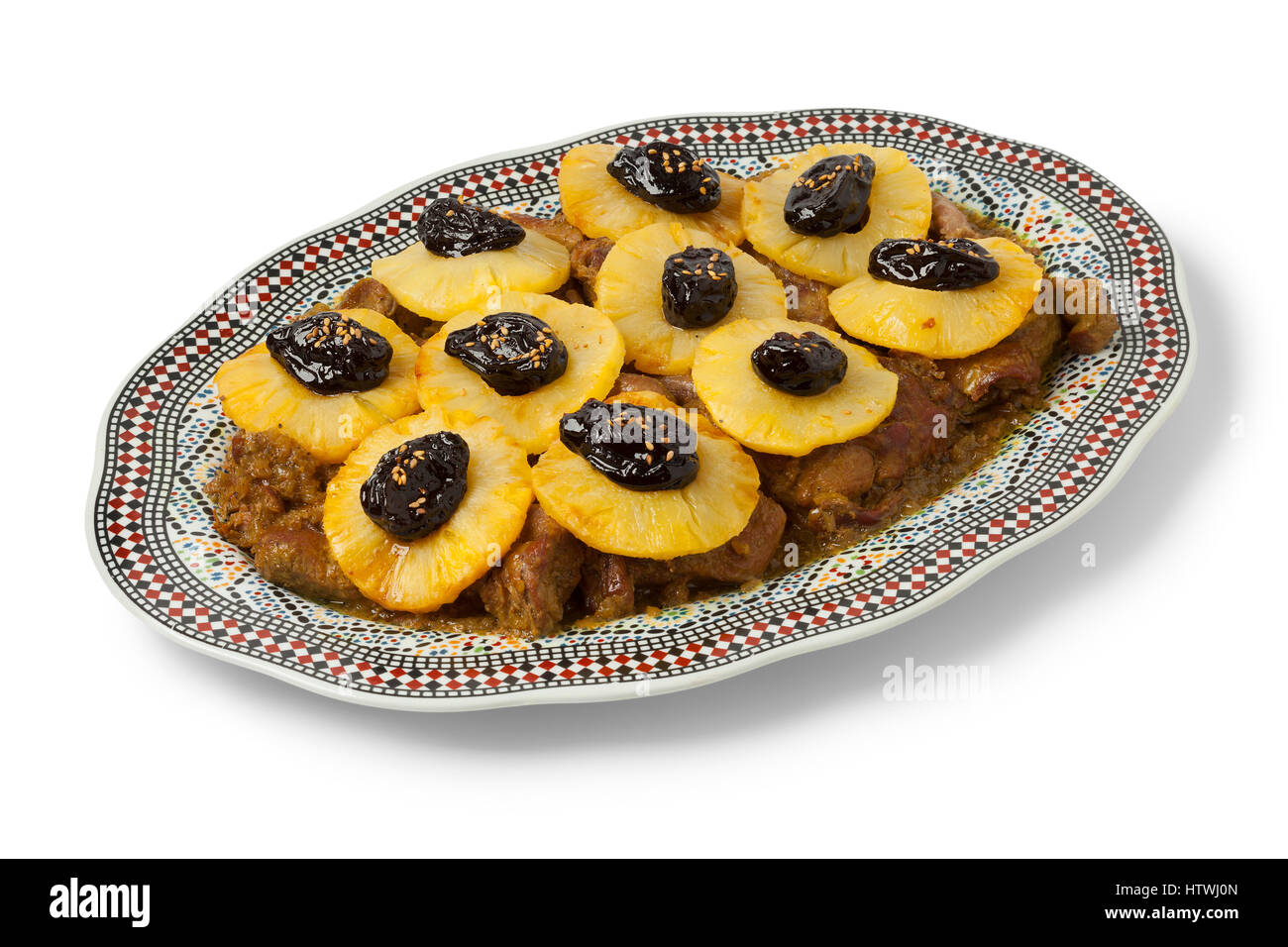 Moroccan dish with meat, pineapple and prunes on white background Stock Photo