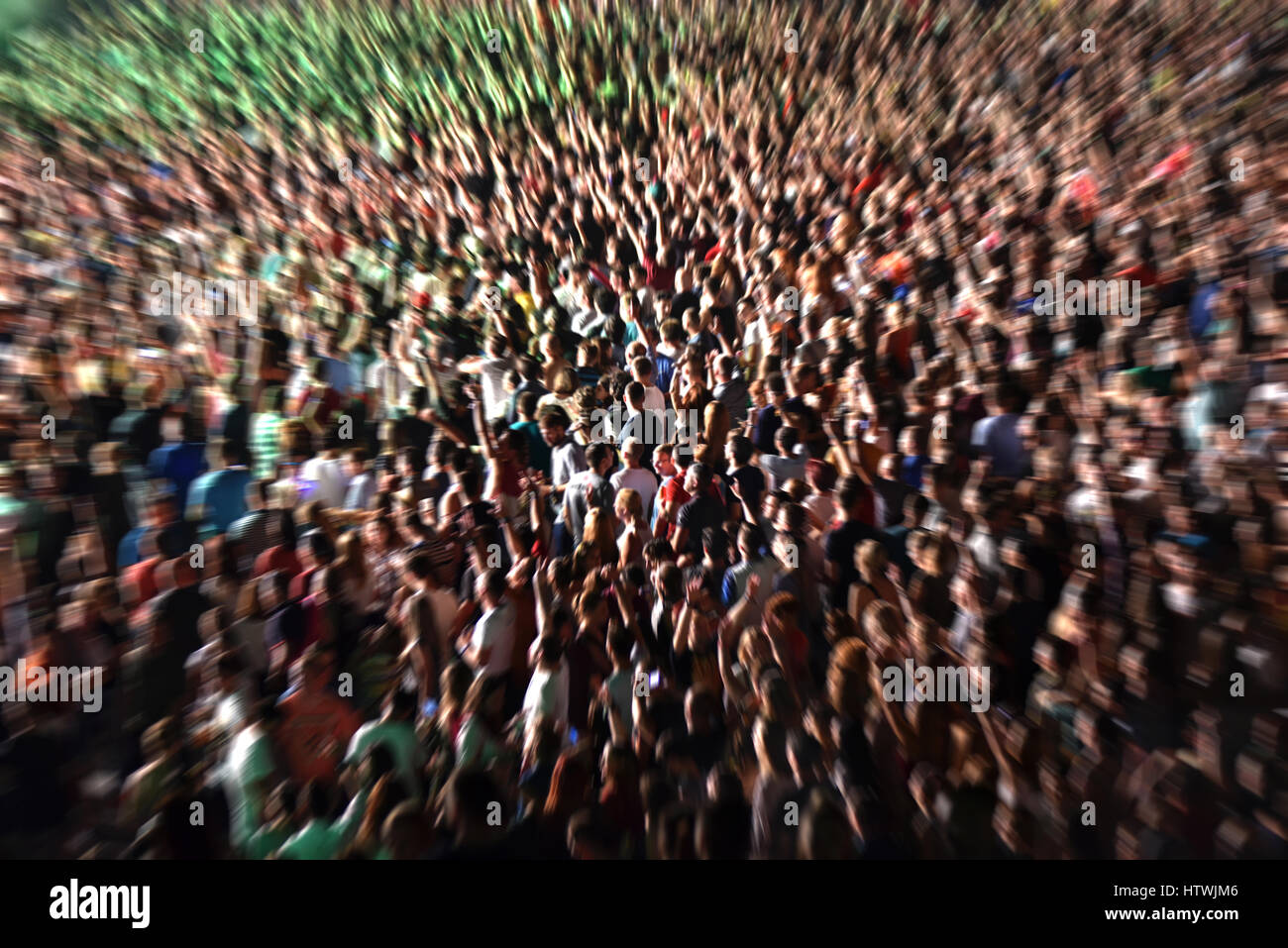 Zoom in effect on a blurred crowd partying at a music festival Stock ...
