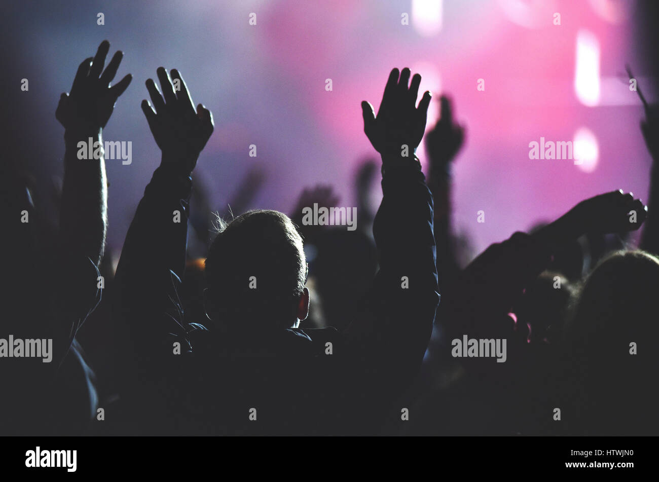 Rear view of crowd with arms outstretched at concert Stock Photo - Alamy