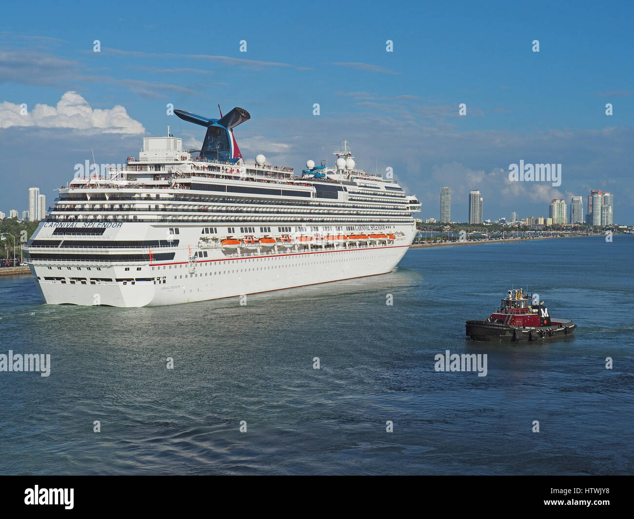 Carnival Splendor cruise ship assisted by tugboat leaving Port of Miami. Stock Photo