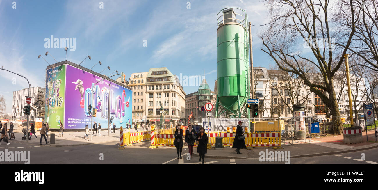 DUESSELDORF, GERMANY - MARCH 13, 2017: Unidentifeied pedestrants pass the construction area at the end of famous Königsallee Stock Photo