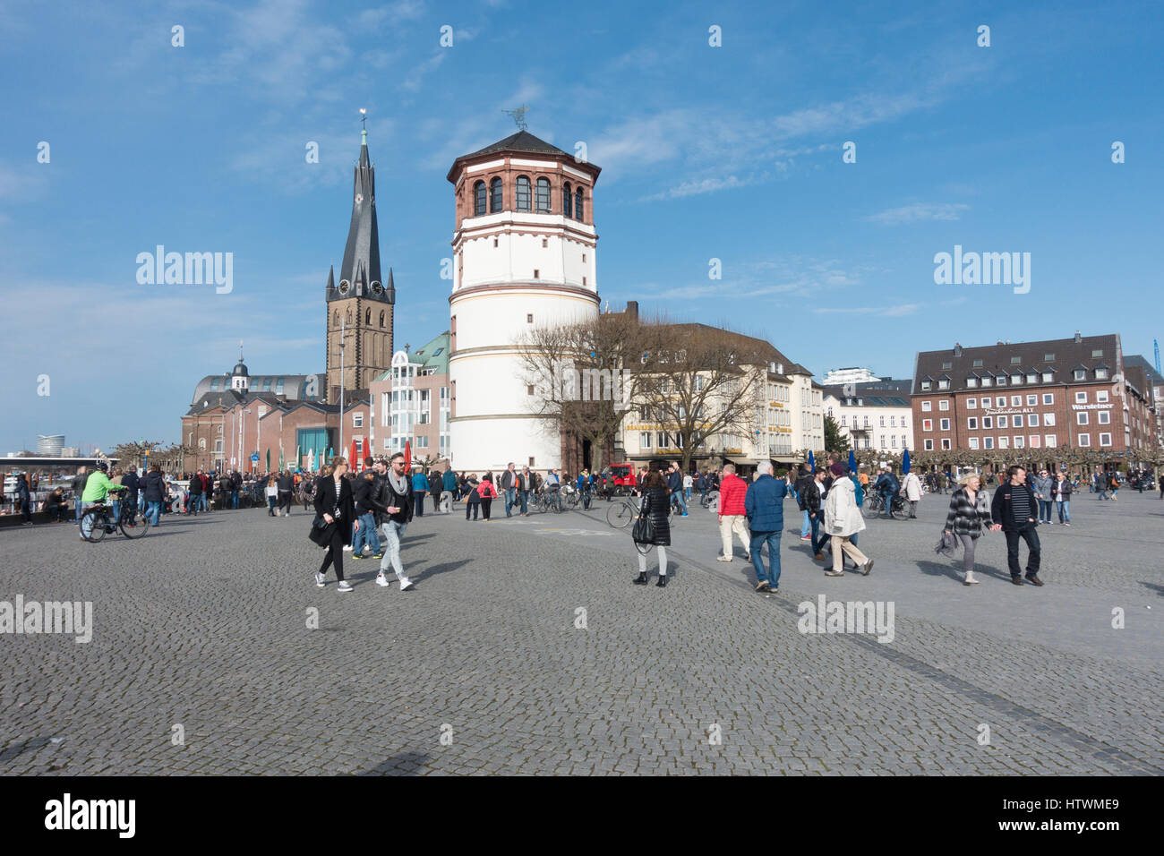 DUESSELDORF, GERMANY - MARCH 12, 2017: Unidentified pedestrants crossing a plaza at the river Rhine Stock Photo