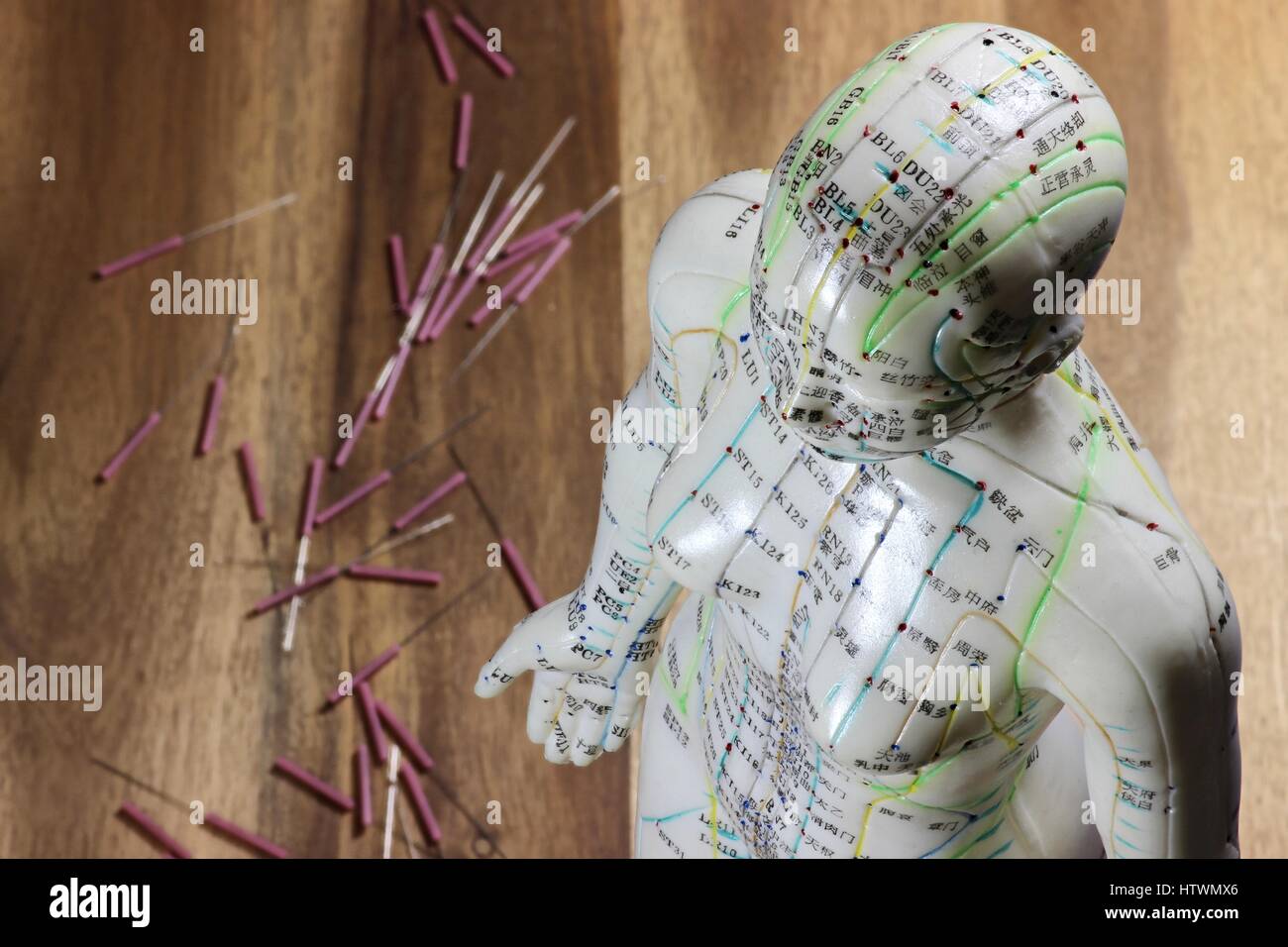 female acupuncture model on wooden background Stock Photo Alamy