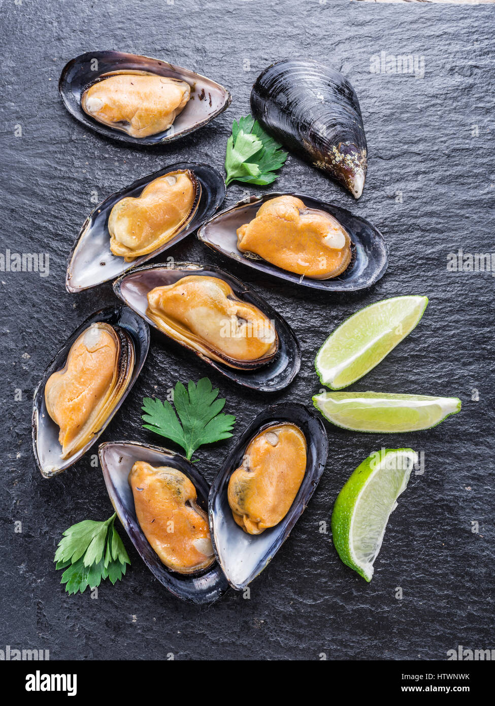 Boiled mussels on the graphite background. Stock Photo