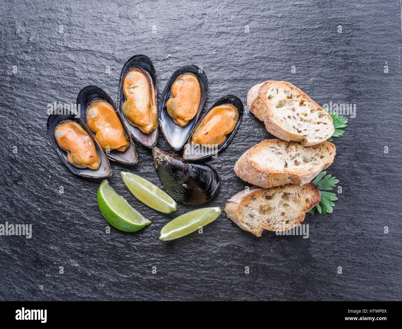 Boiled mussels on the graphite background. Stock Photo