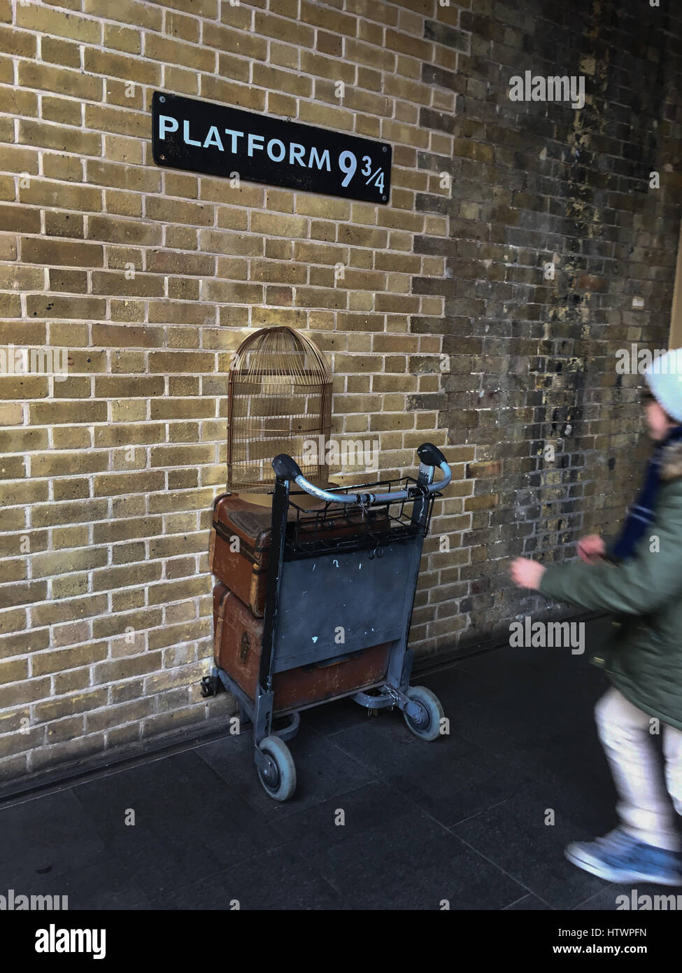 Platform ( & 3/4, for the train to Hogwarts School for Wizards, from Harry Potter stories, at King's Cross Station, London, England. Stock Photo