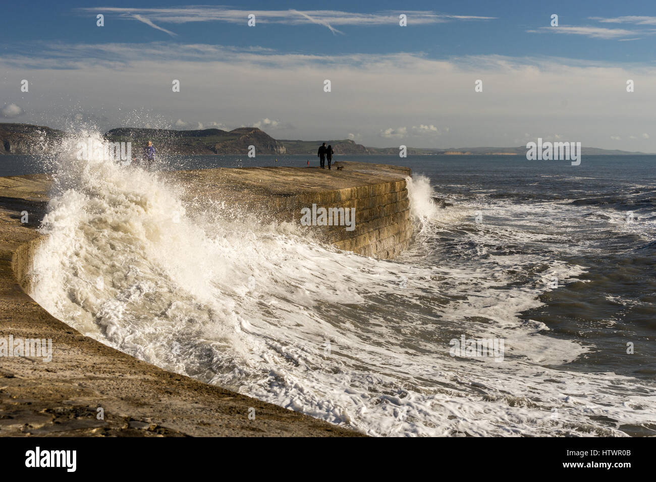 Stromy weather and high waves breaking during the daytime on the UK coast in Lyme Regis Dorset Stock Photo