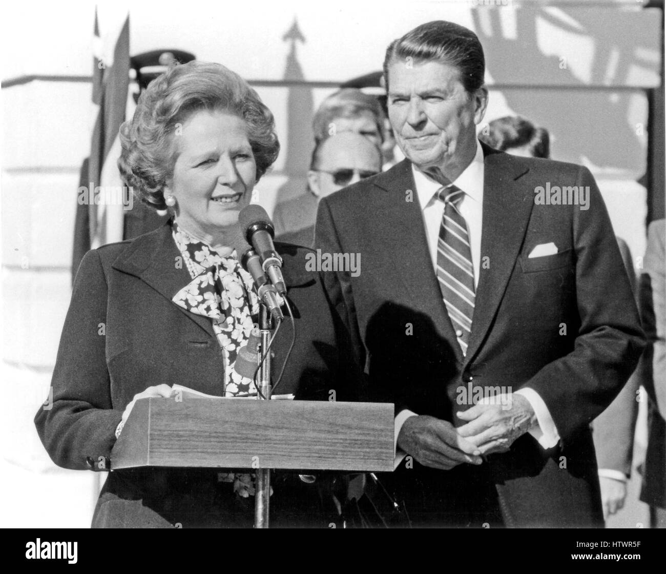 Prime Minister Margaret Thatcher of Great Britain, left, makes a statement following their 2 hour meeting as United States President Ronald Reagan, right, listens in outside the Diplomatic Entrance of the White House in Washington, D.C on Wednesday, Febru Stock Photo