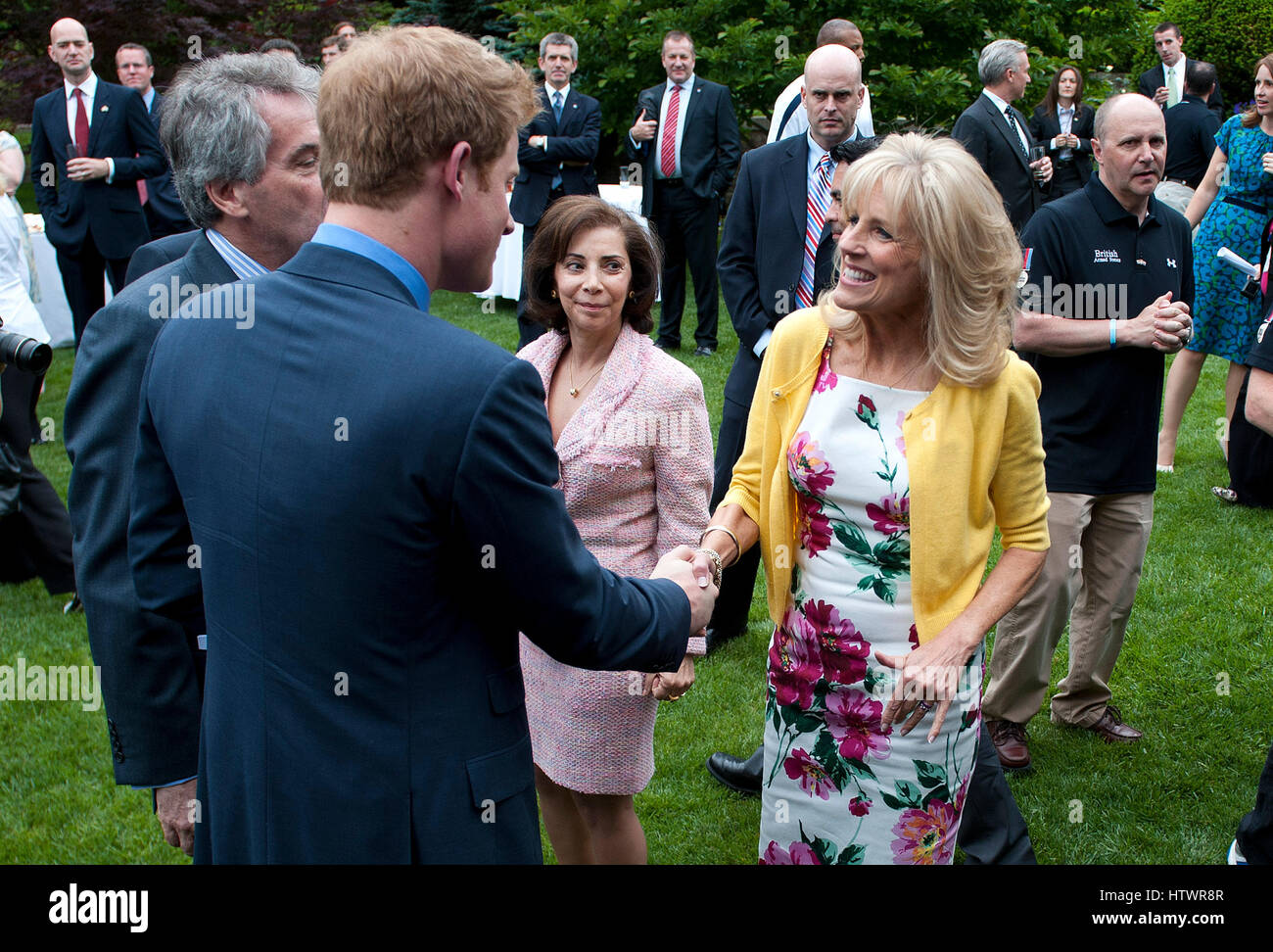 Prince Harry greets Dr Jill Biden (R), the wife of U.S Vice President Joe Biden, during a reception for U.S and British wounded warriors at the British Ambassador's Residence in Washington, D.C on May 7, 2012 . Stock Photo