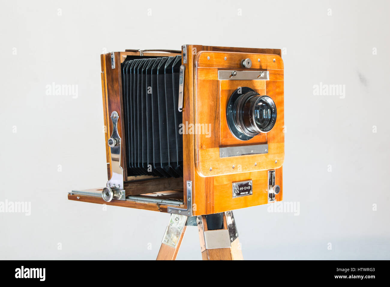 Old vintage big studio camera of wood and metal on white 
