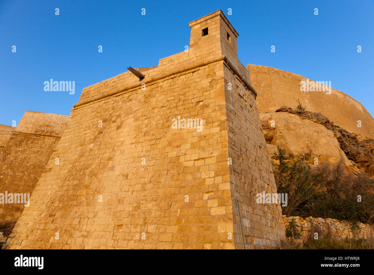 The multi-tiered and forbidding fortifications of the Citadel in Gozo have complex defensive features such as bastions and even a redoubt jutting out  Stock Photo