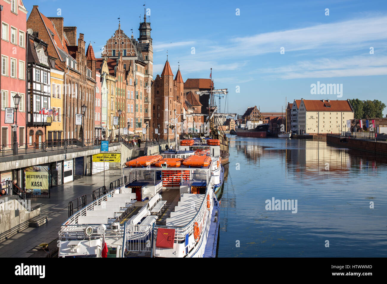 Gdansk, Danzig an old medieval polish and german city, the old granary - Krantor. View on sunny day with blue sky from the river side. Motlawa, Motlau Stock Photo