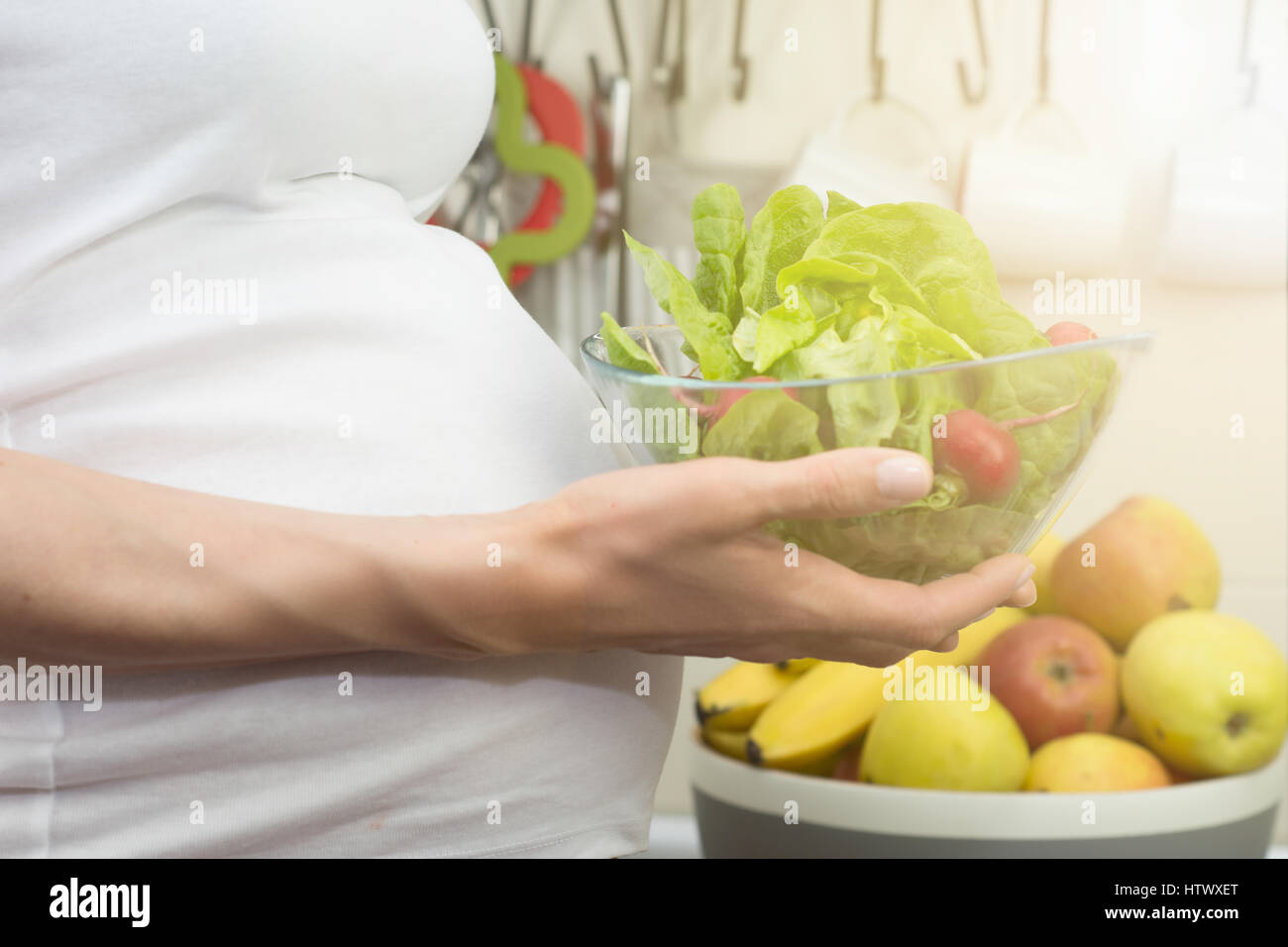 Healthy nutrition and pregnancy. pregnant woman's belly and vegetable