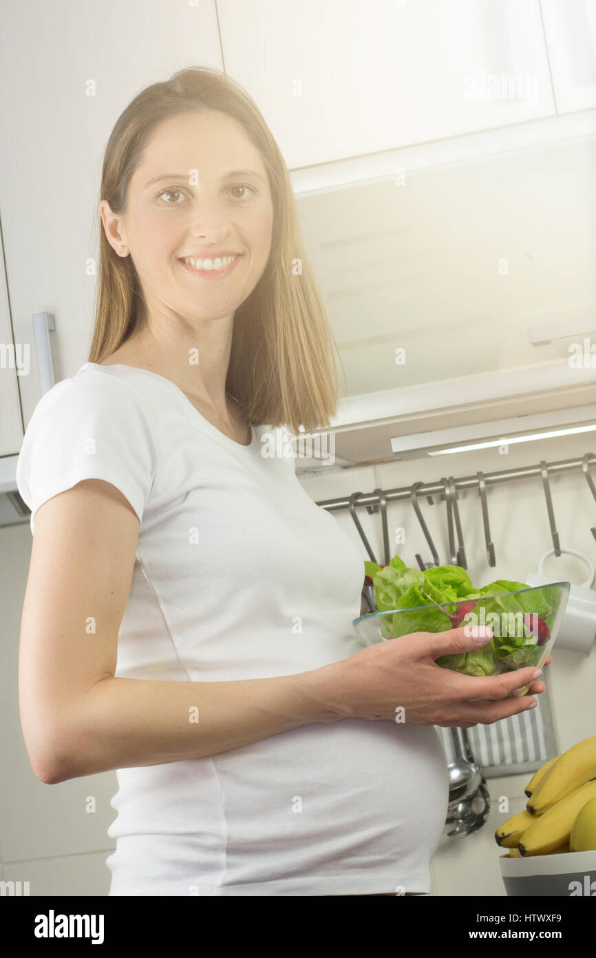 Healthy nutrition and pregnancy. pregnant woman's belly and vegetable