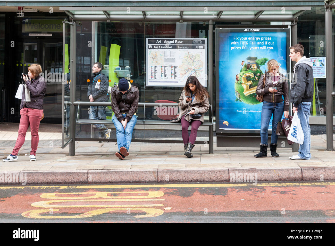People waiting at a bus stop, Nottingham, England, UK Stock Photo