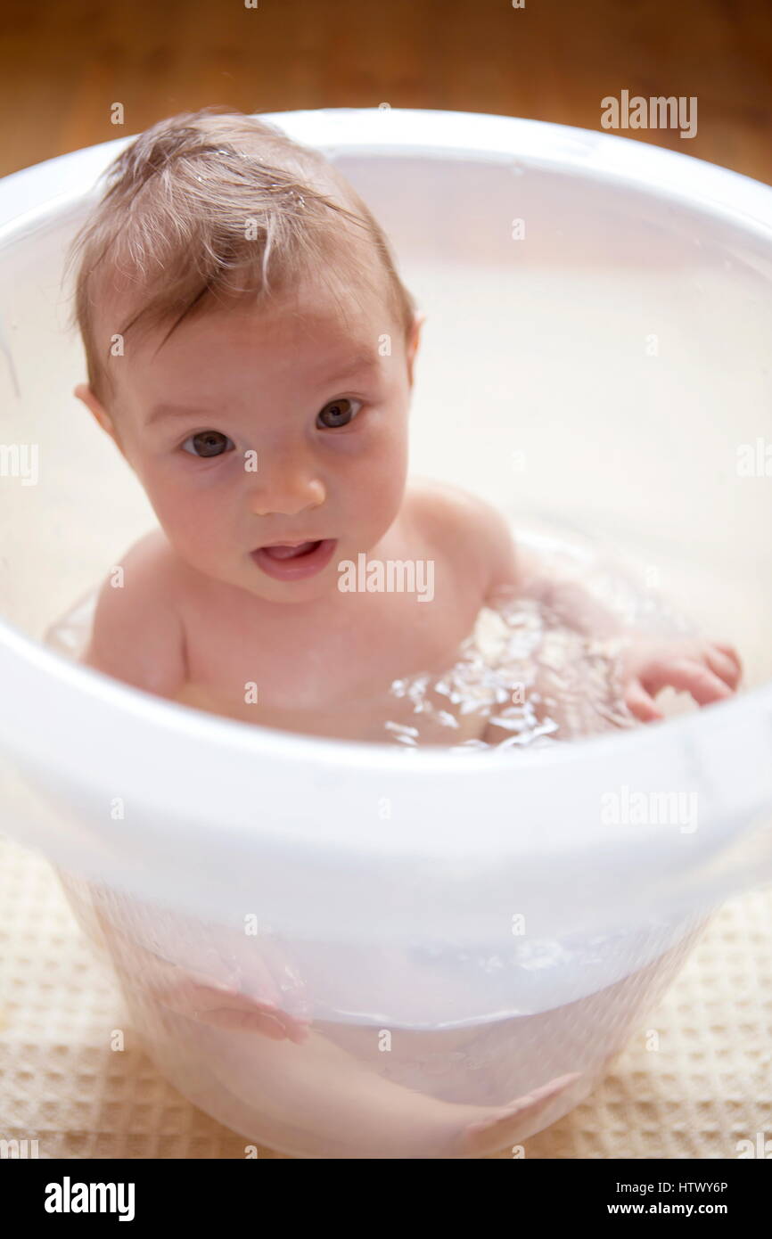 Detail 2 weeks old baby,bucket,bathing,Baby bathed in Baby Bath Stock Photo