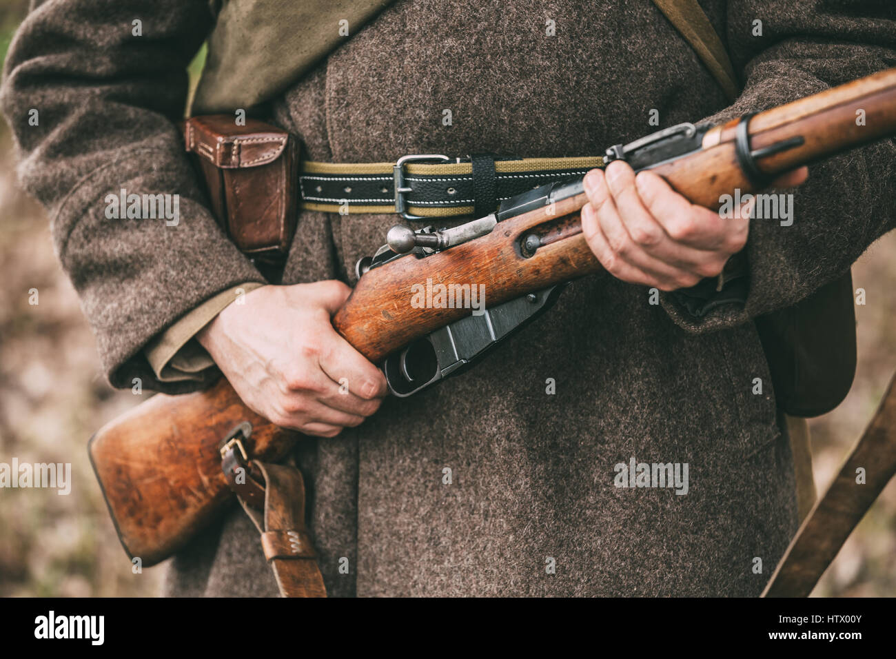 Re-enactor Dressed As Russian Soviet Infantry Soldier Of World War II Holds Rifle Weapon In Hands. Stock Photo