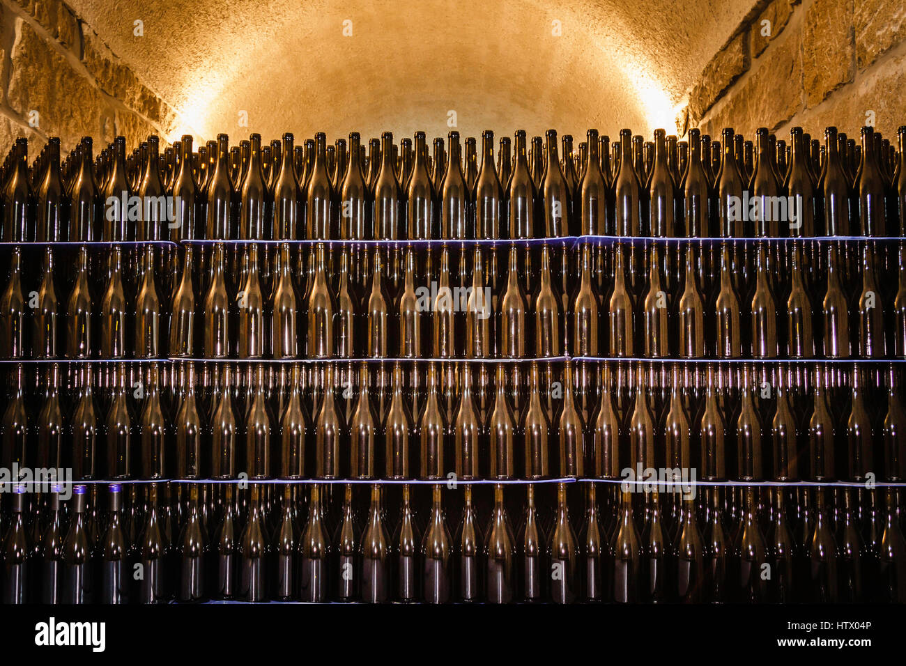 A stack of red wine bottles making an abstract pattern in the cellar at the Sea Campo Adega. Serra da Estrela Stock Photo