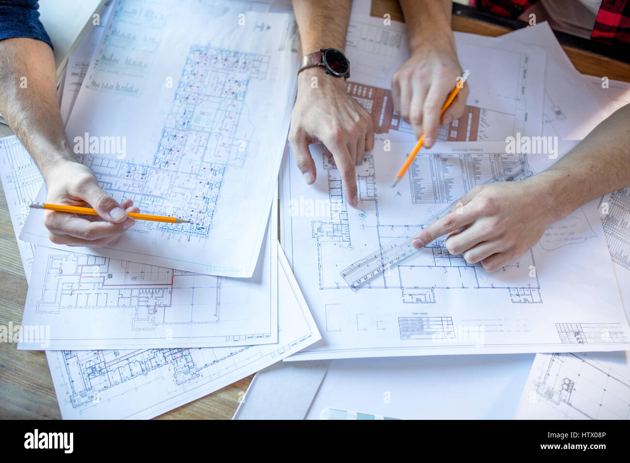Blueprint Discussion Architects discussing blueprints Stock Photo - Alamy