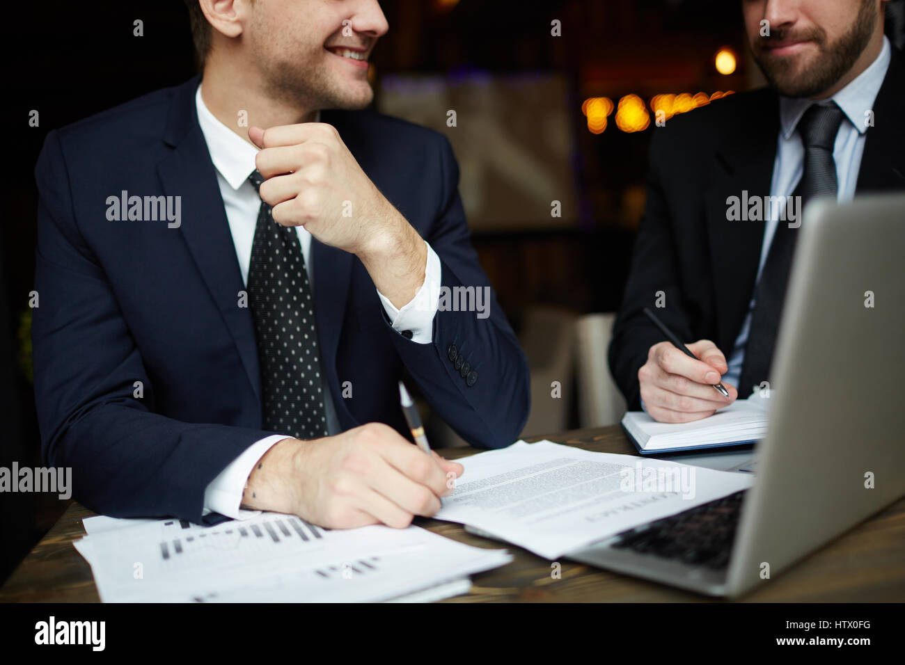Closeup portrait of two unrecognizable successful business partners ...